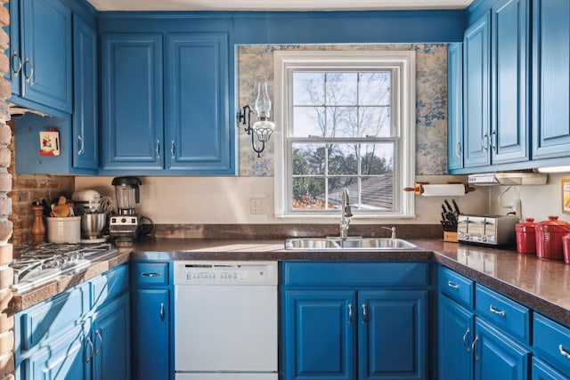 kitchen featuring dishwasher, blue cabinetry, and a sink