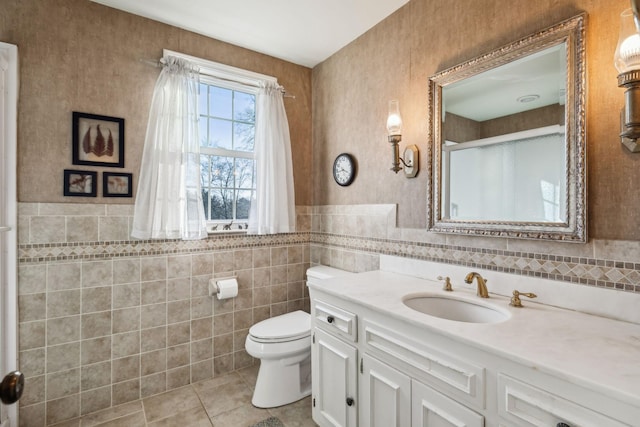 full bathroom with tile patterned flooring, toilet, vanity, tile walls, and a stall shower