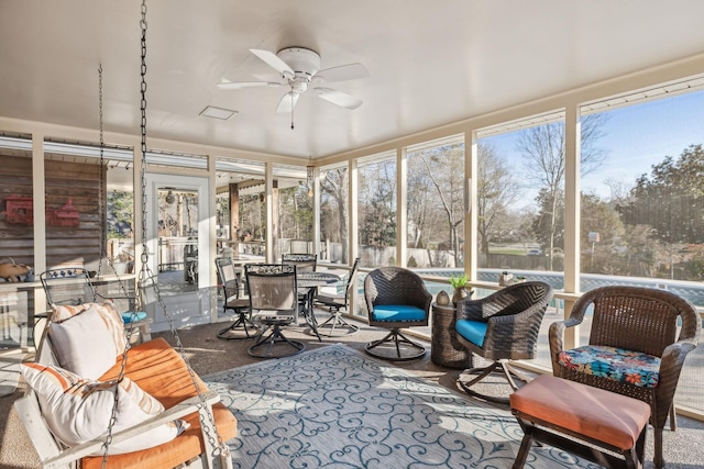 sunroom with a wealth of natural light and a ceiling fan