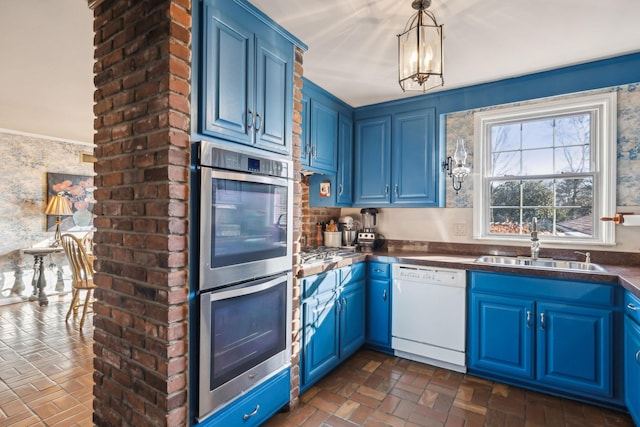 kitchen with blue cabinetry, white dishwasher, and a sink