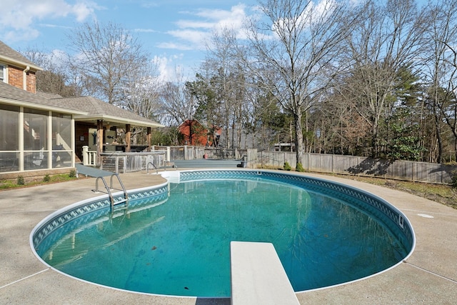 view of swimming pool with a fenced in pool, a patio, outdoor dry bar, a fenced backyard, and a diving board