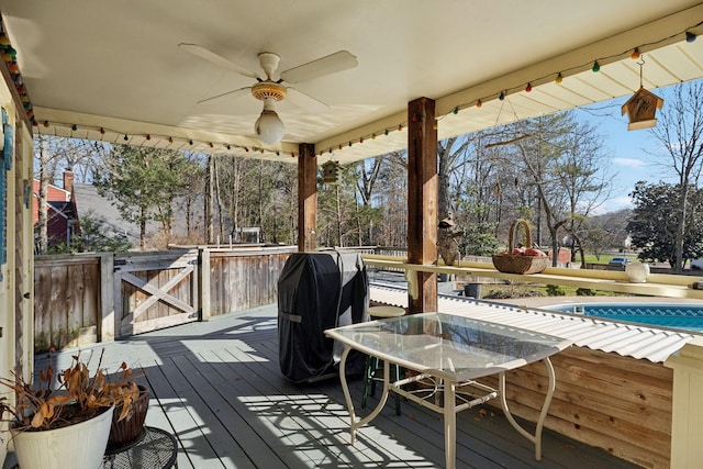 deck with ceiling fan and area for grilling