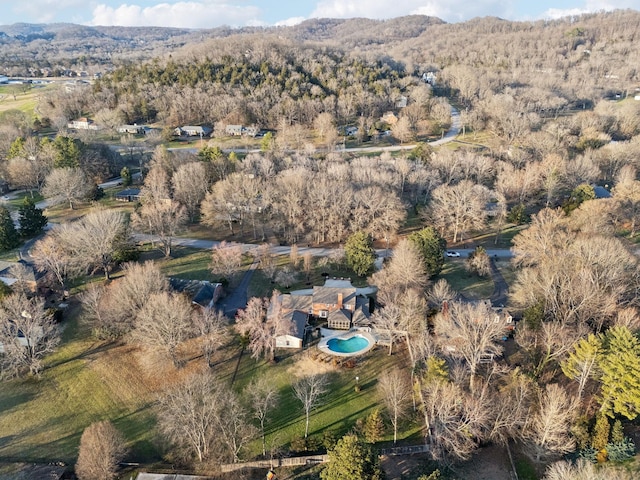 drone / aerial view featuring a forest view and a mountain view