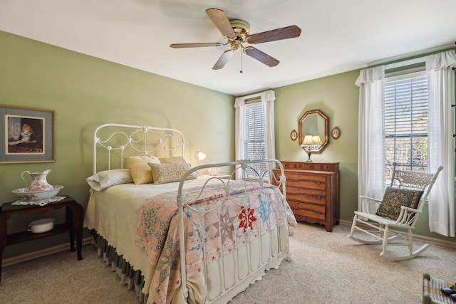 bedroom featuring ceiling fan, carpet, and baseboards