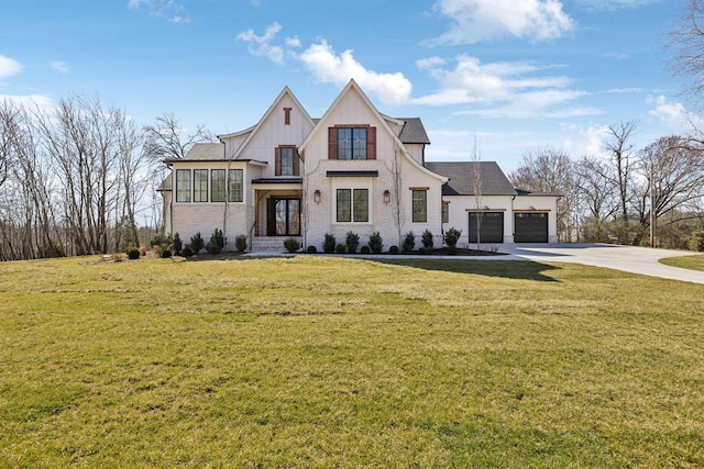 modern farmhouse style home with a garage, driveway, a front lawn, and board and batten siding