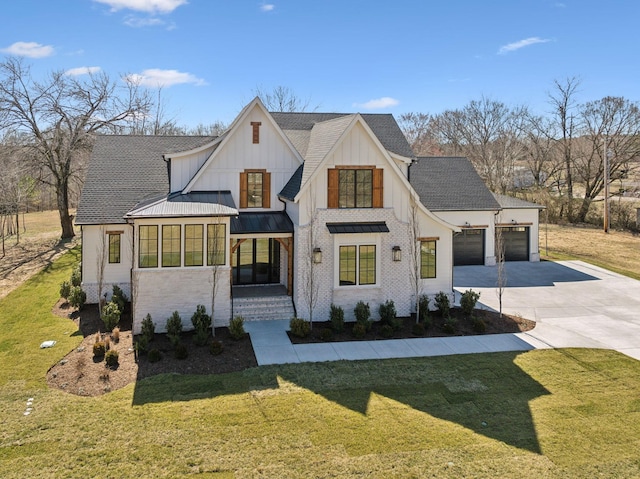 modern farmhouse style home with board and batten siding, a standing seam roof, a garage, driveway, and a front lawn