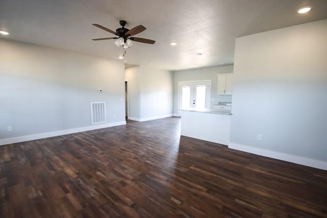 spare room featuring baseboards, visible vents, a ceiling fan, dark wood-type flooring, and recessed lighting