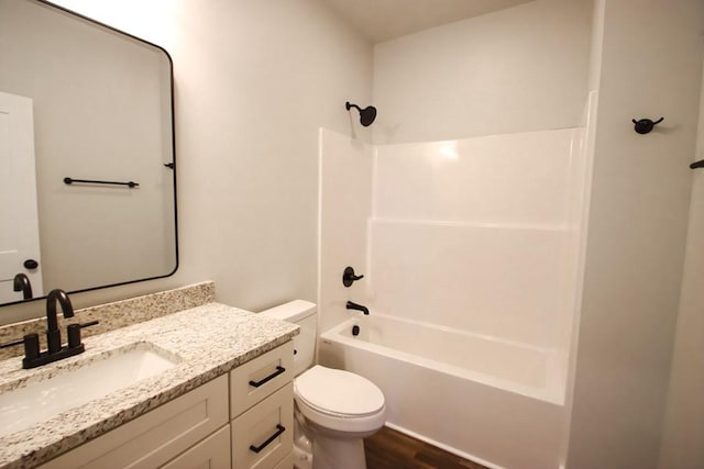 full bath with shower / washtub combination, vanity, toilet, and wood finished floors