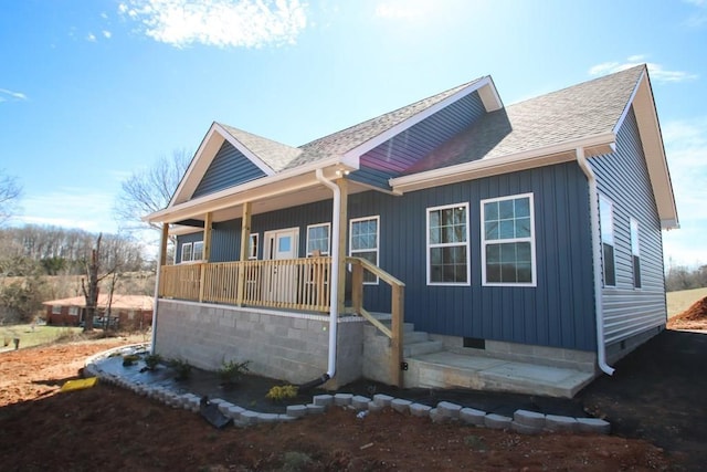 view of front facade with a porch, crawl space, and a shingled roof