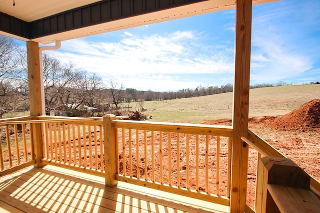 wooden deck with a rural view