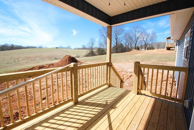 wooden terrace featuring a rural view