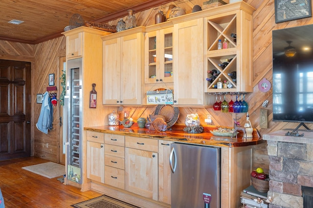 kitchen with refrigerator, light brown cabinetry, wooden walls, wood finished floors, and wooden ceiling