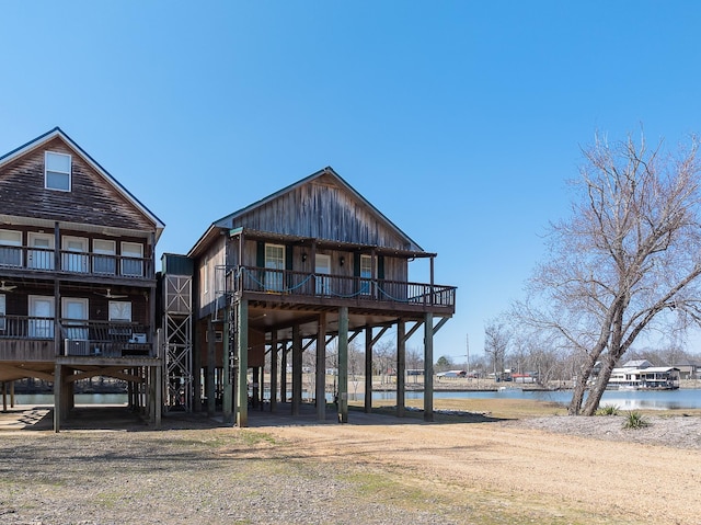 rear view of house featuring a carport and a water view