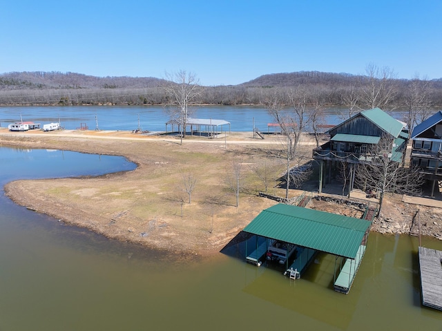 dock area with a water view and boat lift