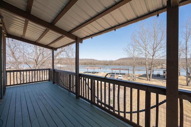 wooden terrace featuring a water view