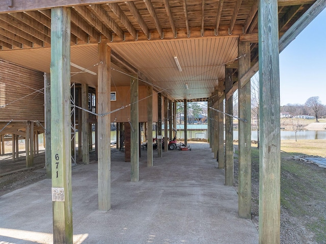 view of patio featuring an exterior structure and a water view