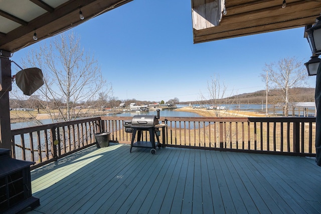 deck featuring a water view and a grill