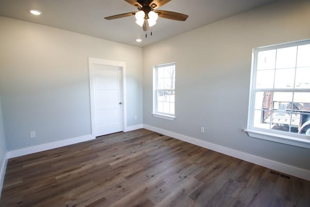 spare room with recessed lighting, wood finished floors, a ceiling fan, and baseboards