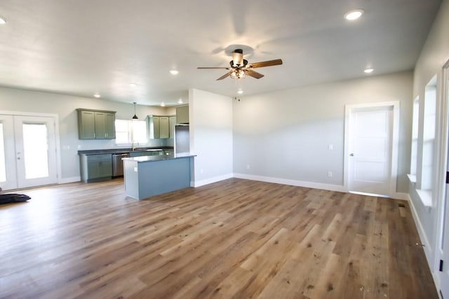 kitchen with refrigerator, recessed lighting, wood finished floors, dishwasher, and baseboards