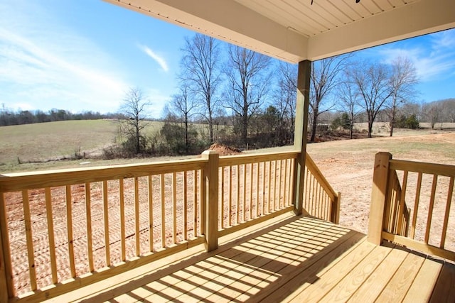 wooden terrace featuring a rural view