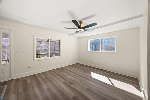 spare room with visible vents, baseboards, ceiling fan, and dark wood-style flooring