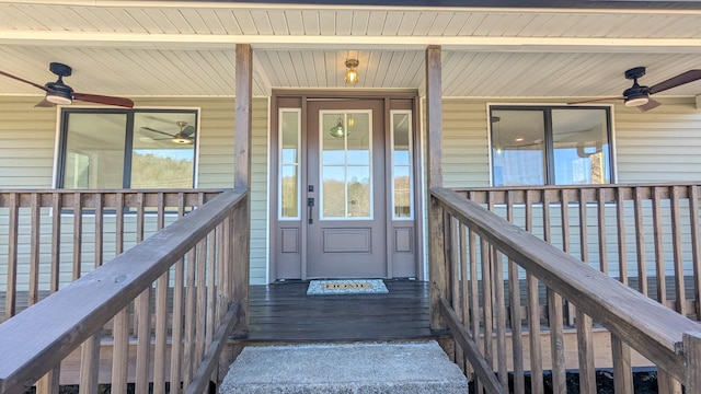 entrance to property with a porch and a ceiling fan