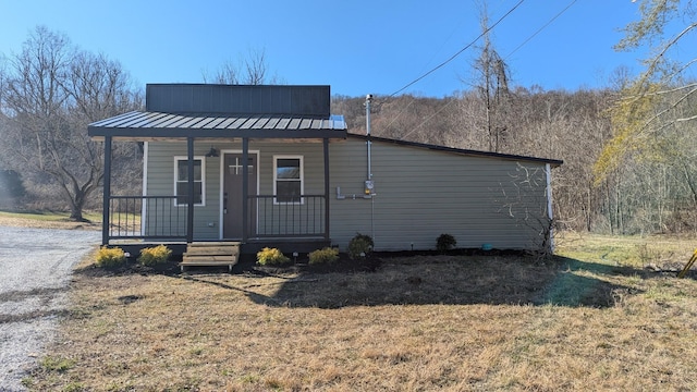 view of front facade featuring metal roof and a porch