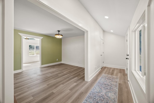 foyer entrance with light wood finished floors, recessed lighting, and baseboards