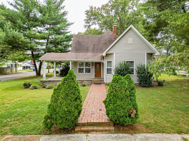 view of front of house featuring a shingled roof, a chimney, an attached carport, a porch, and a front yard