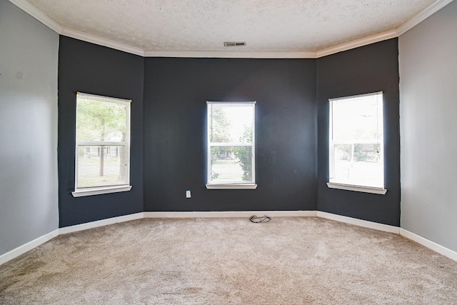 carpeted empty room with a textured ceiling, ornamental molding, visible vents, and baseboards