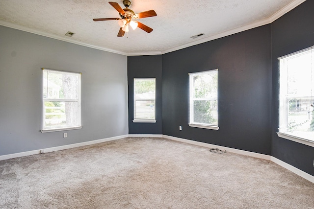 carpeted empty room with a textured ceiling, visible vents, and crown molding