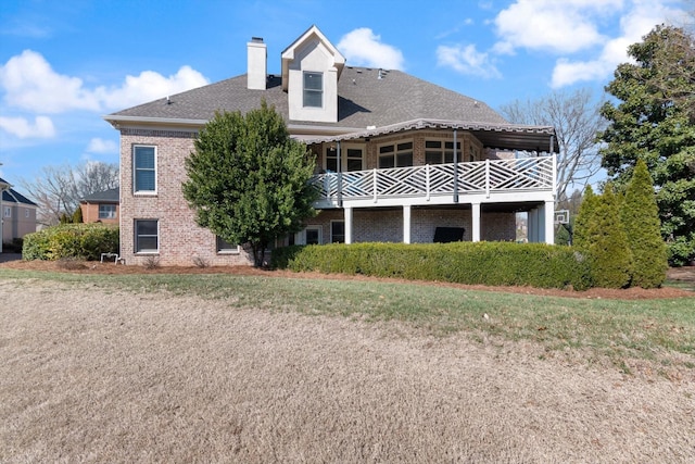 rear view of property with brick siding and a chimney