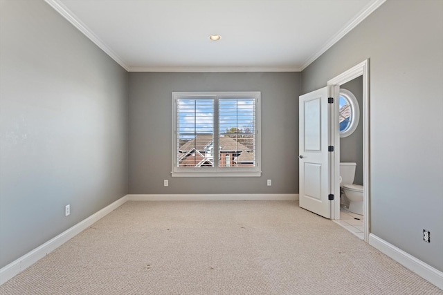 unfurnished bedroom featuring ornamental molding, light colored carpet, and baseboards