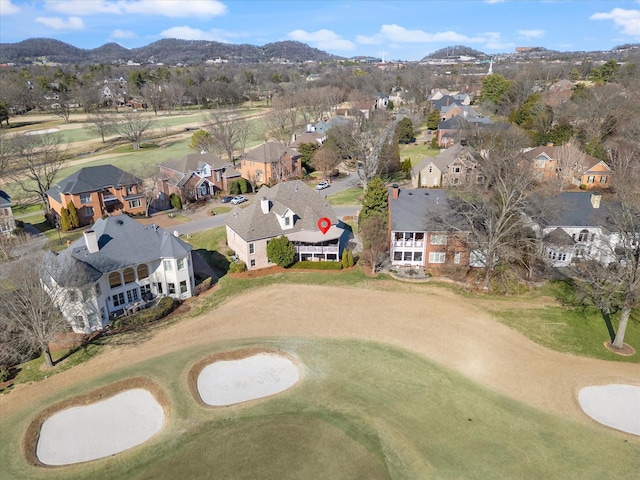 birds eye view of property with a mountain view, view of golf course, and a residential view