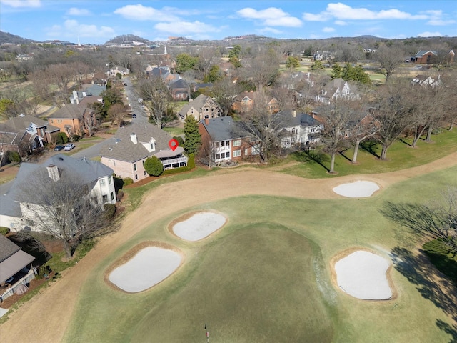 drone / aerial view featuring view of golf course and a residential view