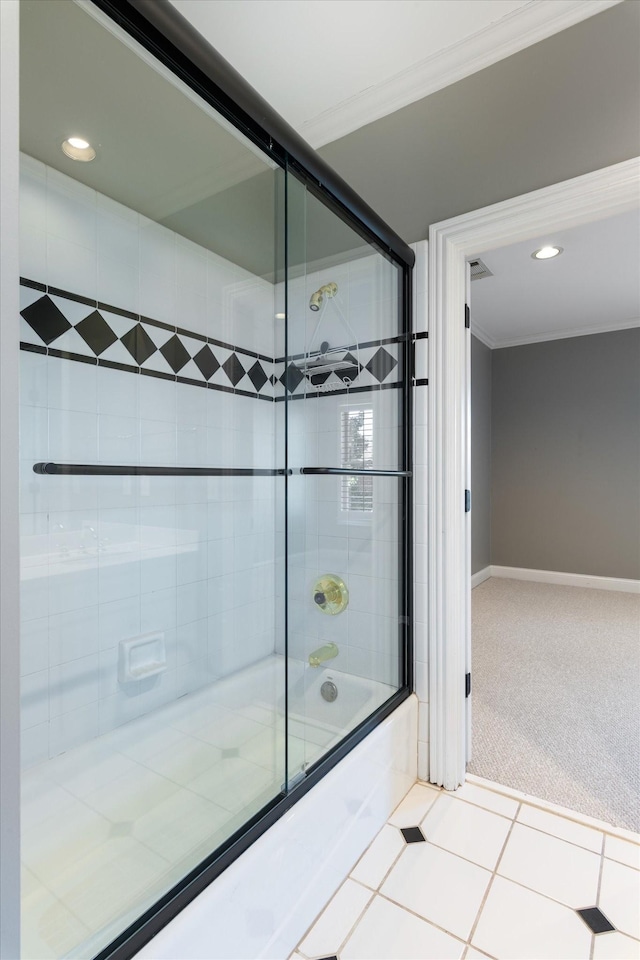 full bathroom featuring ornamental molding, shower / bath combination with glass door, baseboards, and tile patterned floors