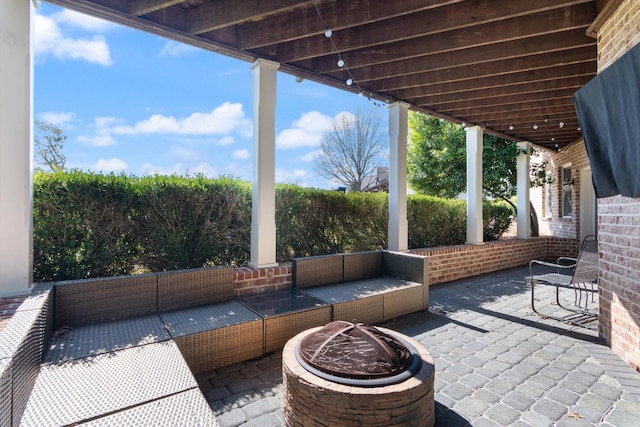 view of patio featuring an outdoor living space with a fire pit