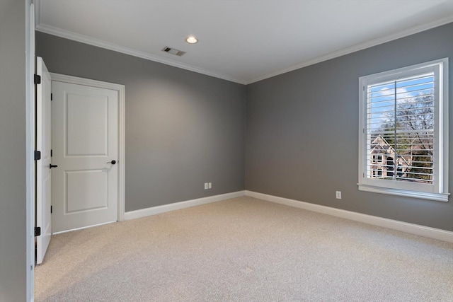 unfurnished room featuring visible vents, crown molding, light carpet, and baseboards