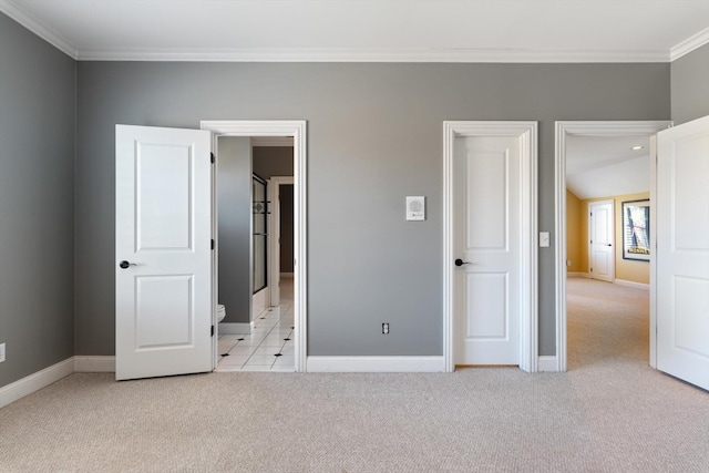 unfurnished bedroom featuring baseboards, ornamental molding, and light colored carpet