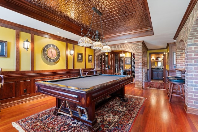 playroom with arched walkways, pool table, ornamental molding, wainscoting, and an ornate ceiling