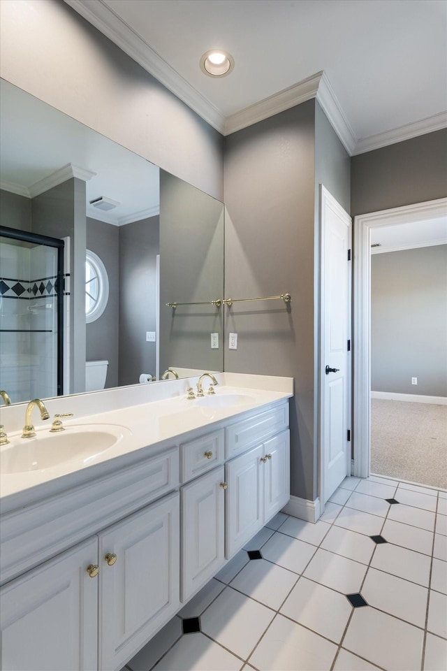 bathroom with ornamental molding, a sink, toilet, and baseboards