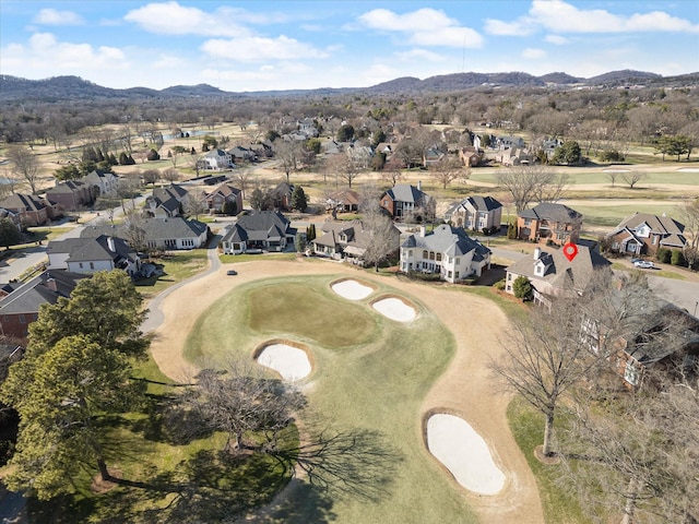 drone / aerial view with a residential view, a mountain view, and golf course view