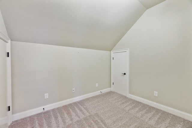 bonus room featuring lofted ceiling, carpet, and baseboards