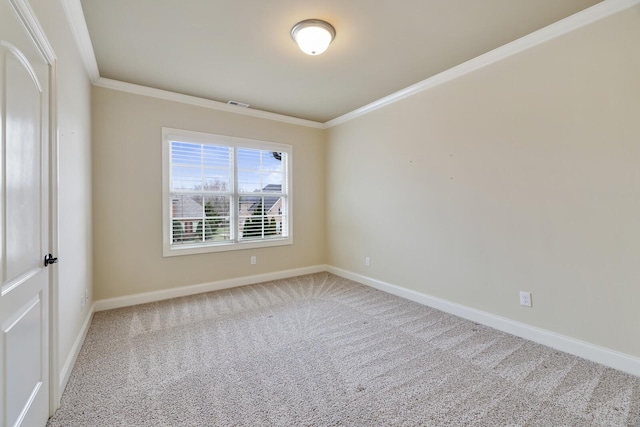 empty room featuring ornamental molding, carpet, visible vents, and baseboards