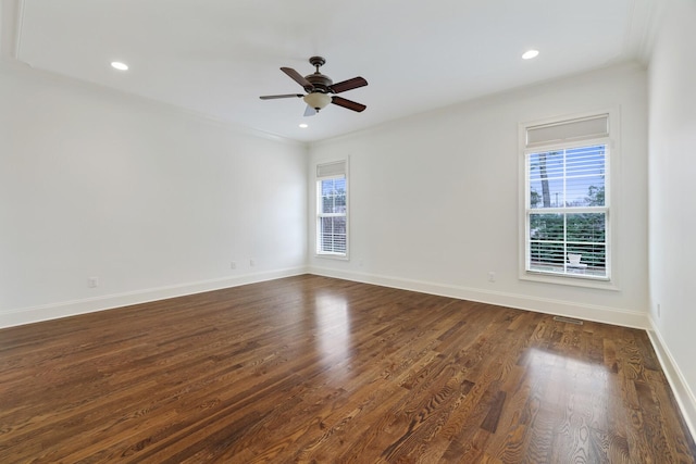 empty room featuring baseboards, dark wood-style flooring, and recessed lighting