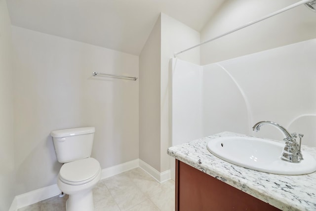 bathroom featuring tile patterned flooring, baseboards, vanity, and toilet