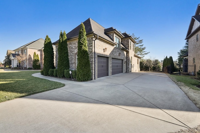 view of home's exterior featuring a shingled roof, concrete driveway, brick siding, and a yard