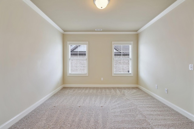 carpeted spare room featuring visible vents, crown molding, and baseboards