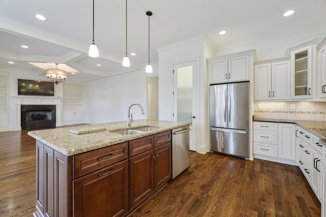 kitchen featuring stainless steel appliances, glass insert cabinets, a sink, and dark wood-style floors