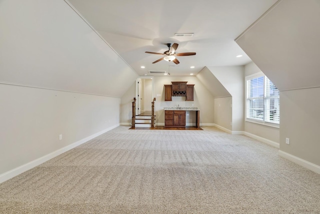 additional living space with light carpet, visible vents, baseboards, lofted ceiling, and recessed lighting